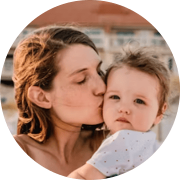 woman kisses baby
