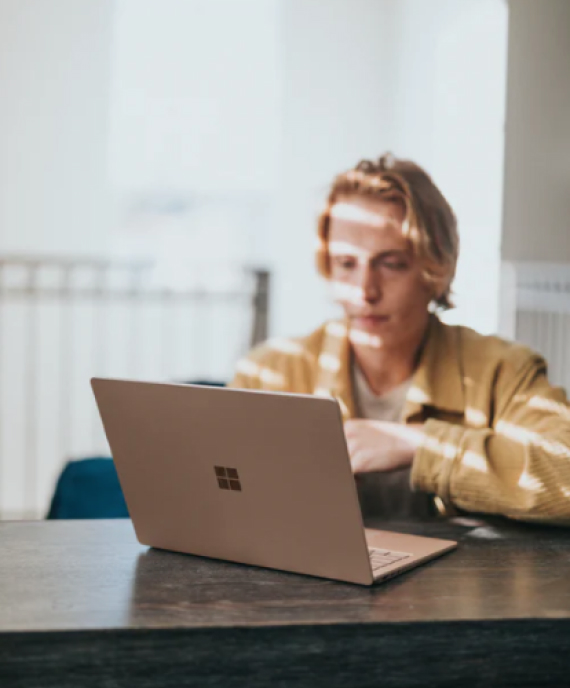 Guy sitting behind a laptop computer